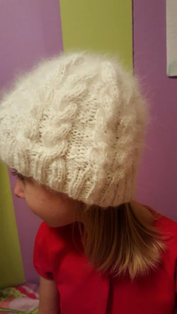   Side view of the hat [made using Running Bug's Moonstone English Angora rabbit wool]. It    now has a tassel on top. Will post pic of it tomorrow.