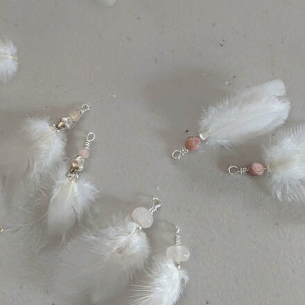 Customer appreciation photo of earrings using running bug farm better than organic tiny white chicken feathers.