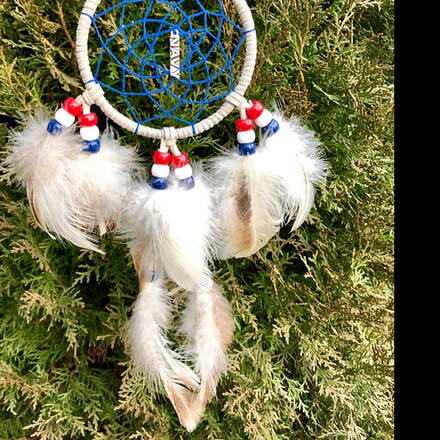 Picture of a US Navy themed hand made dream catcher using natural feathers from Running Bug Farm.