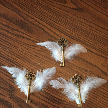 Picture of hand made Harry Potter themed flying keys using real feathers from Running Bug Farm.  Created and reviewed by Kristen B. - These feathers worked perfect for my HP flying keys that I made for a bridal shower!