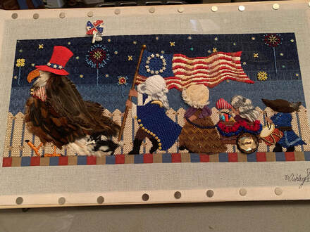 Picture of patriotic cross stitch work using real birds feathers. Bald eagle. American Flag.