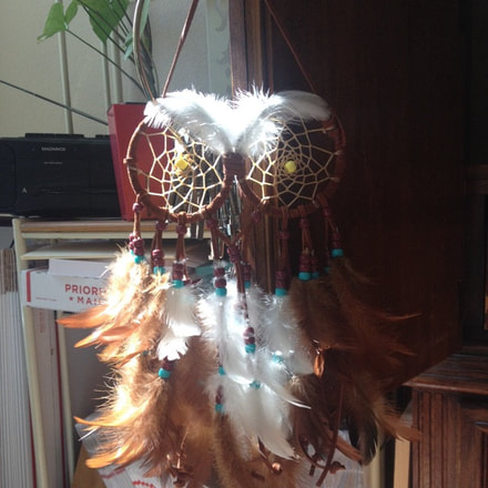 Customer appreciation photo of a owl feather wall hanging.  Feathers are from Running Bug Farm.