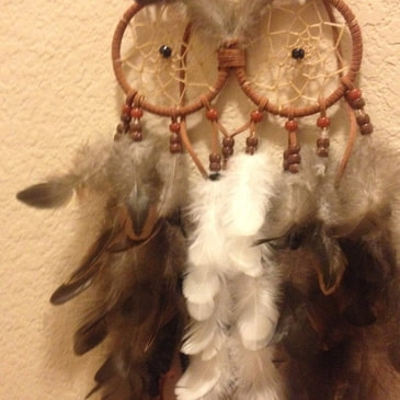 Feather owl wall hanging made from humane feathers from Running Bug Farm.  Customer photo.