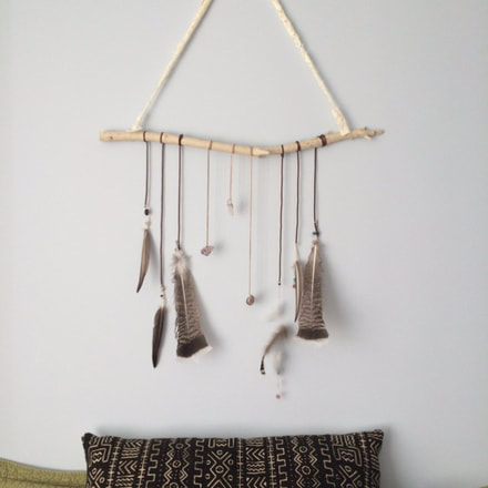 Customer appreciation photo of a feather wall hanging made with real bird feathers from Running Bug Farm.
