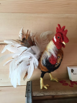 Appreciation photo of a felted rooster using feathers from Running Bug Farm.