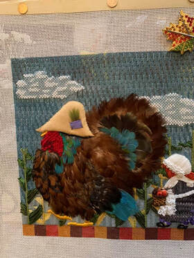 Customer photo of needlepoint using real bird feathers from running bug farm.